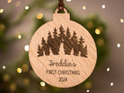 Wooden bauble with outdoor scene featuring a snowman