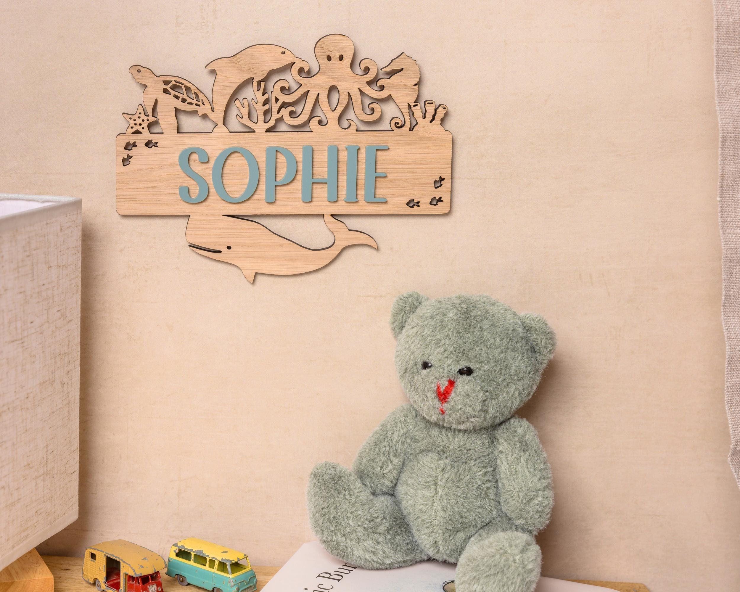 Wooden name sign with ocean creatures.