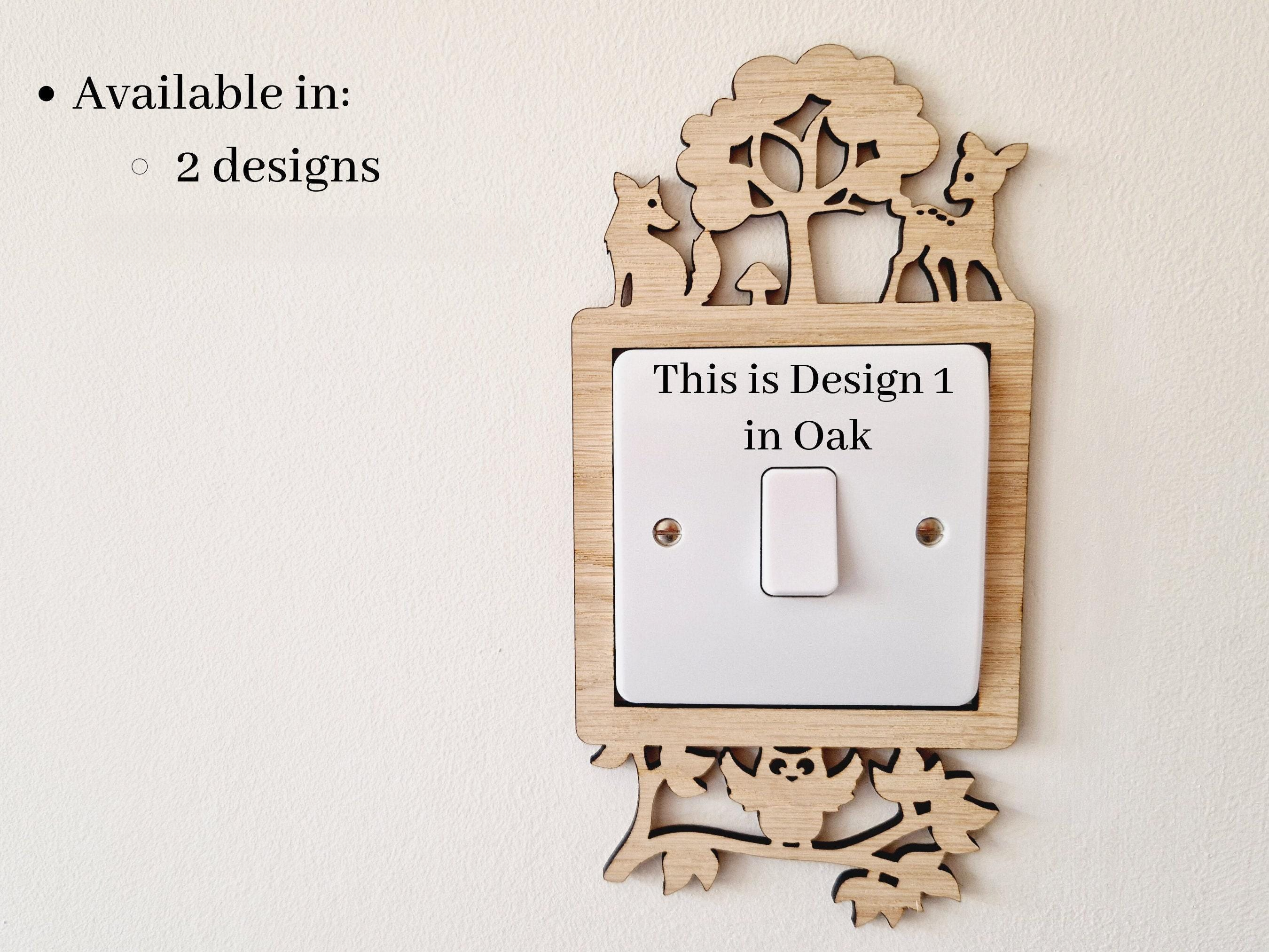 a wooden light switch surround with a cut out woodland scene design with a deer, fox and owl. 