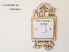 a wooden light switch surround with a cut out woodland scene design with a deer, fox and owl. 