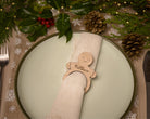 Wooden napkin ring with a gingerbread man design.