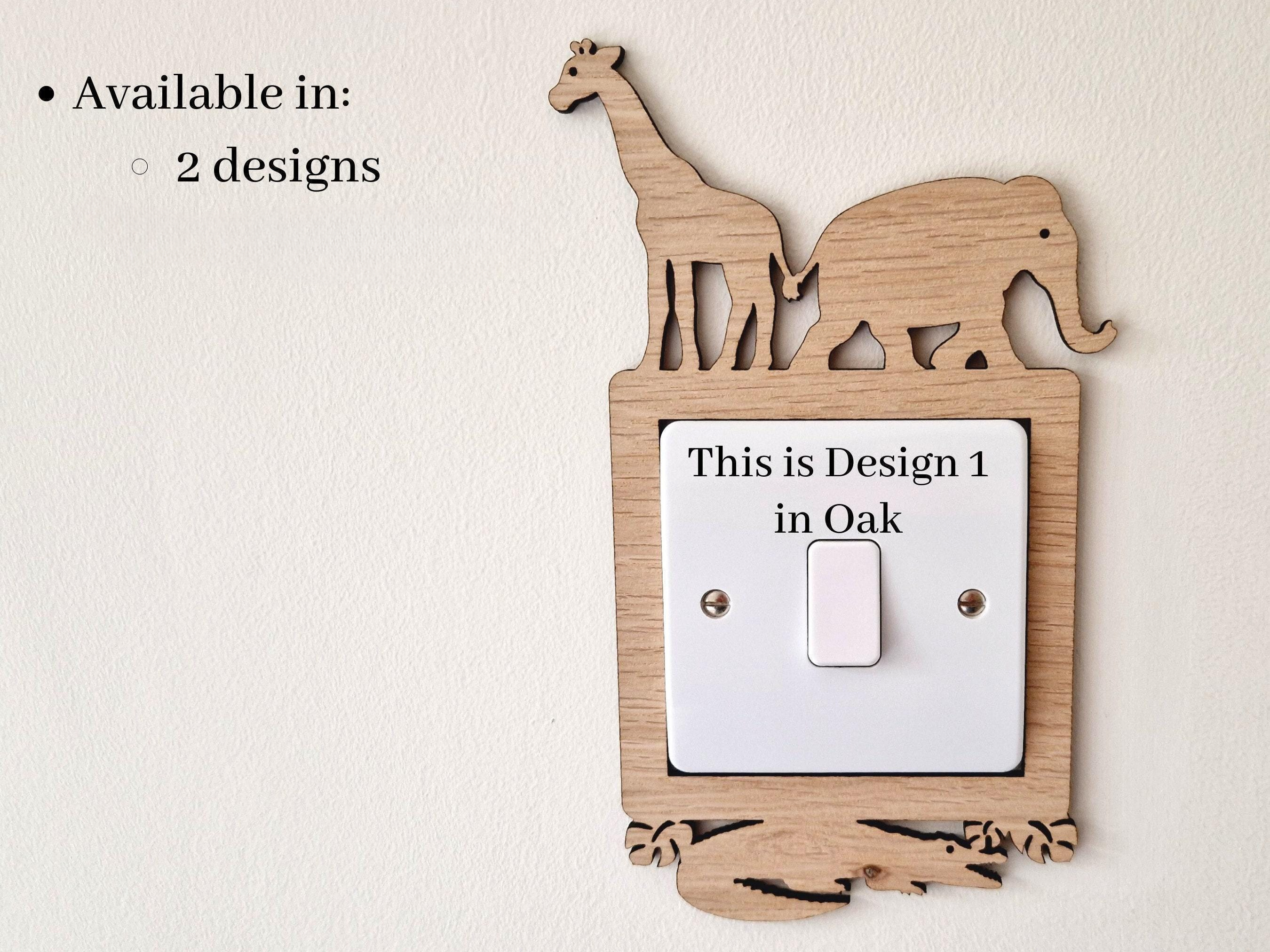 a wooden light switch with a giraffe and an elephant cut out of it, mounted on a wall.
