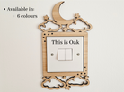 a wooden light switch with a moon and star design, and the text "This is Oak" is displayed on the switch.