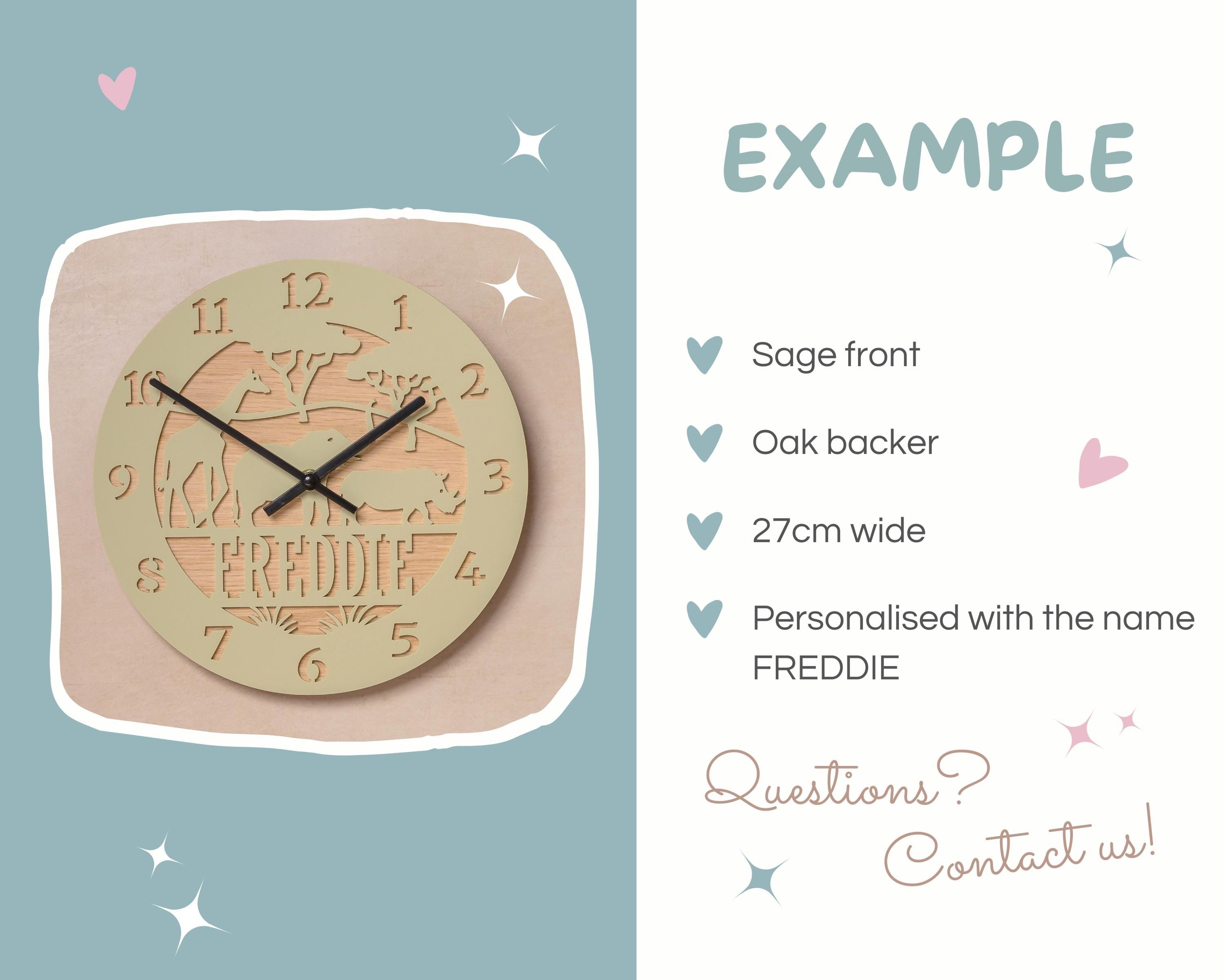 a wooden wall clock with the name "FREDDIE" carved into it. The clock is set against a light blue background with stars scattered around it.