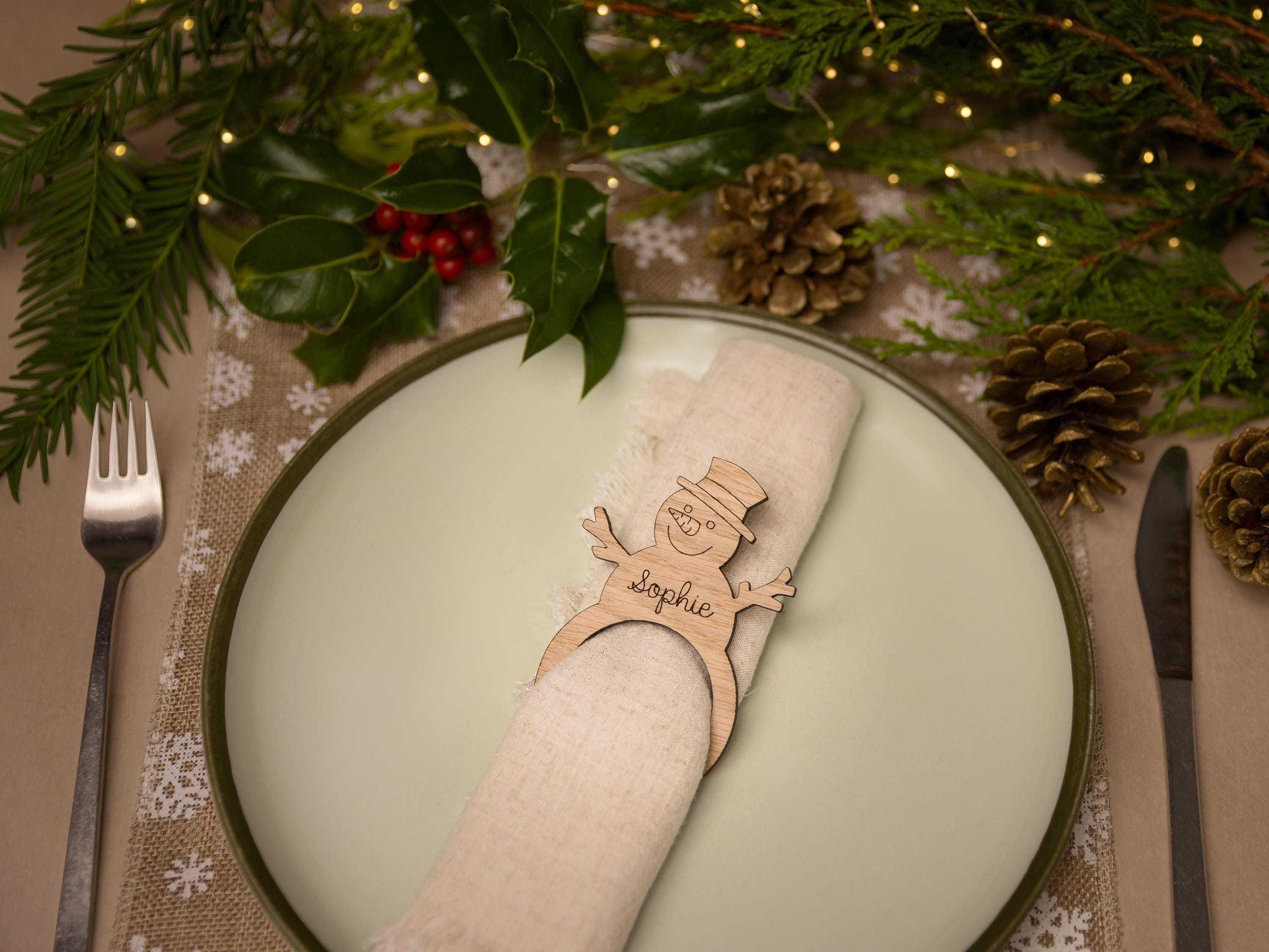 Wooden napkin ring with snowman design.