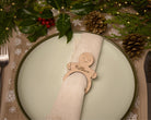 Wooden napkin ring with a gingerbread man design.